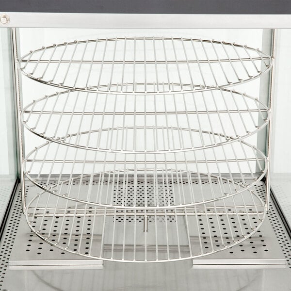 A Nemco countertop pizza merchandiser with 4 metal racks on it.