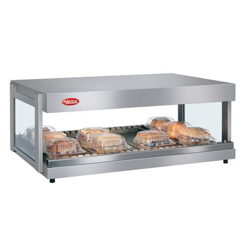 A Hatco stainless steel countertop food warmer with a single shelf holding food trays.