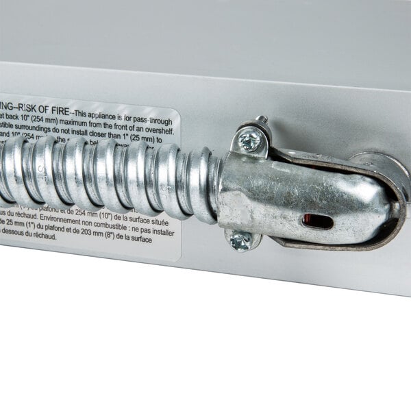 A metal box with a metal hose attached to a metal cable with a screw on the end.