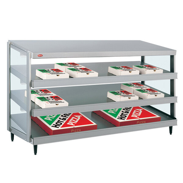 A Hatco countertop pizza warmer with a shelf of pizza boxes inside.