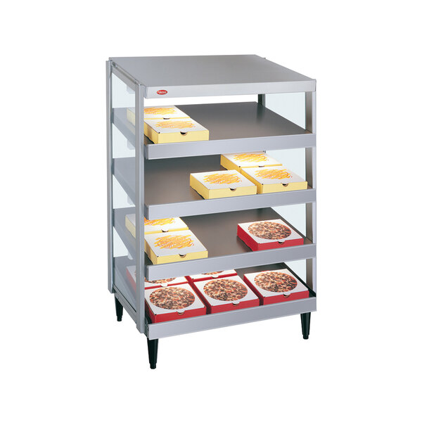 A Hatco countertop pizza warmer with pizza boxes on metal shelves.