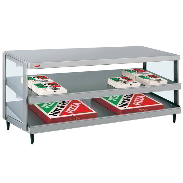A Hatco countertop pizza warmer shelf with pizza boxes inside.