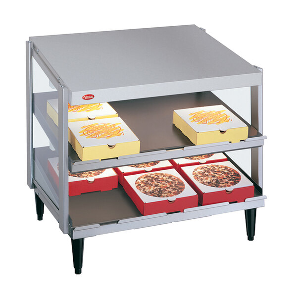 A Hatco countertop pizza warmer shelf with pizza boxes inside.