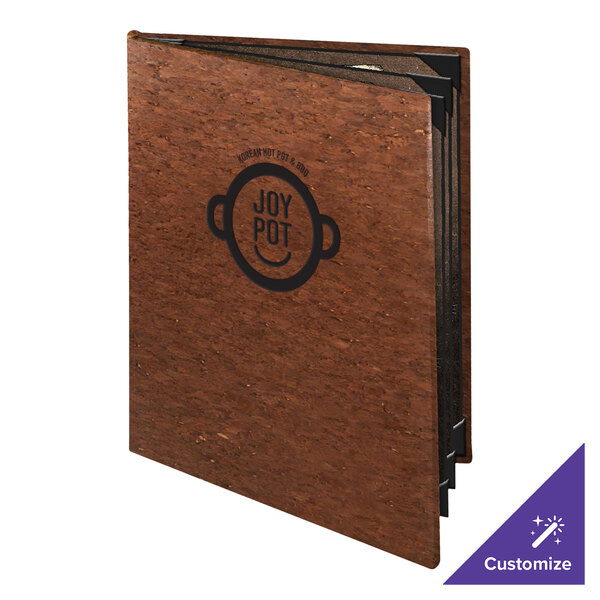 A brown, textured, hardcover booklet with a visible logo and the words 'JOY POT' on the front, shown partially open.