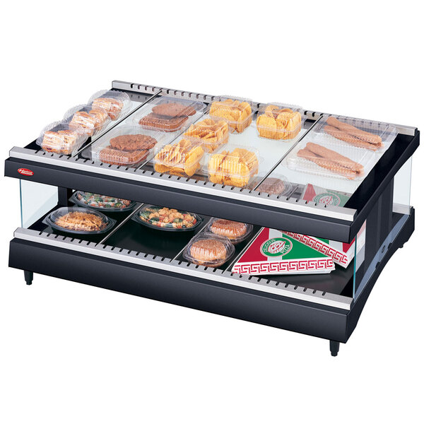 A Hatco countertop food display warmer with food on a shelf inside.