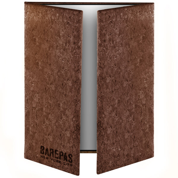 A brown rectangular cork menu cover with white custom text.