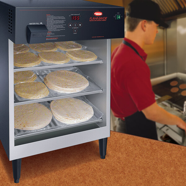 A Hatco Flav-R-Savor heated air curtain holding tortillas.