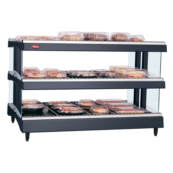 A Hatco countertop display warmer with food on shelves.