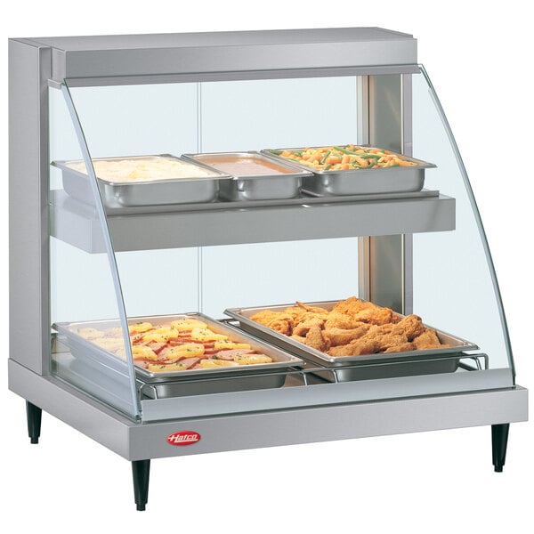 A Hatco Glo-Ray double shelf countertop food display case with food in it.