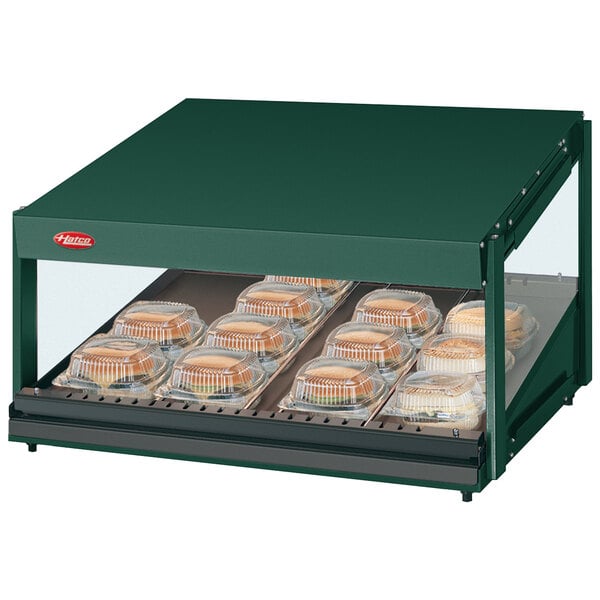 A Hunter Green Hatco countertop food warmer with a slanted shelf of food in containers.