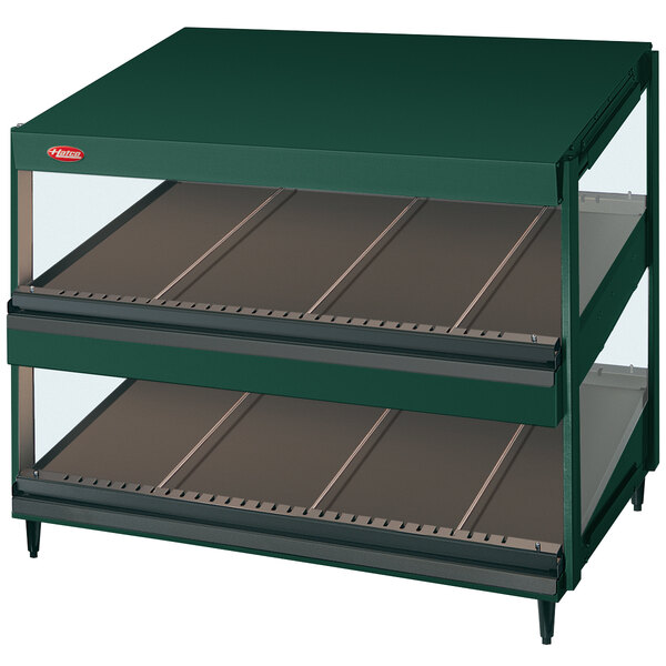 A Hunter Green Hatco Glo-Ray slanted double shelf countertop merchandiser with glass shelves.