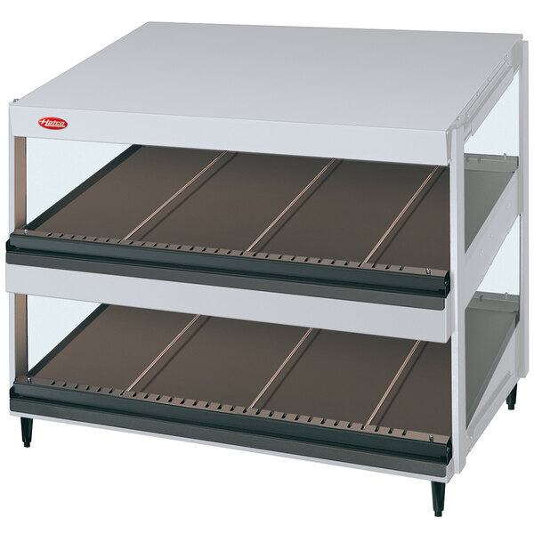 A white Hatco Granite Glo-Ray slanted double shelf with glass shelves.