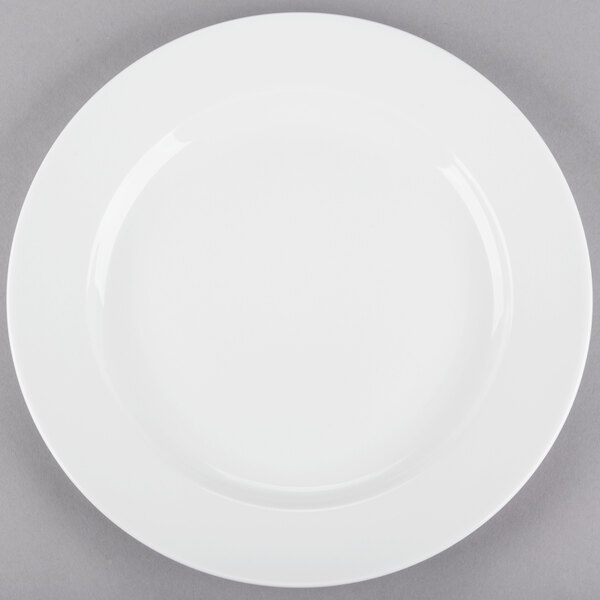 A Tuxton AlumaTux white china plate with a white rim on a gray surface.