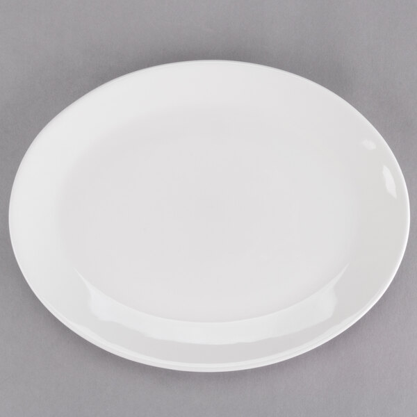A Tuxton oval china platter with a white center and rim on a gray surface.