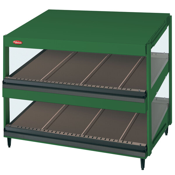 A green Hatco countertop display case with slanted glass shelves.