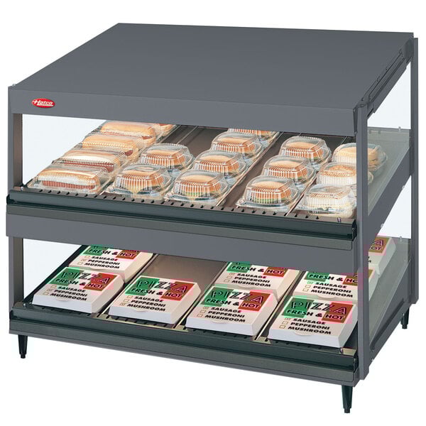 A Hatco countertop display case with food on shelves.