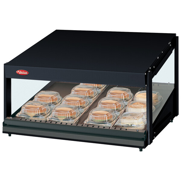 A black Hatco countertop display case with trays of food.