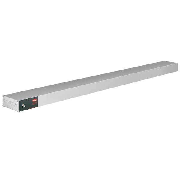 A long rectangular white metal shelf with red lights and a red button.