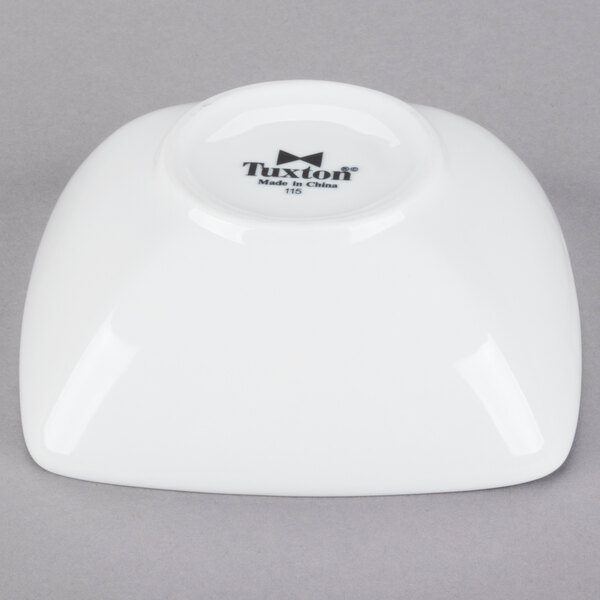 A white Tuxton china bowl with black text that says "Linx" on it.