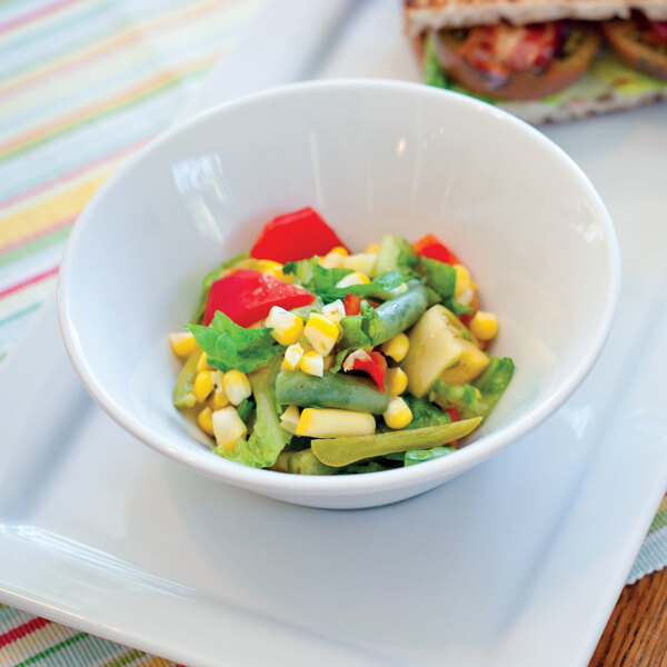 A TuxTrendz Linx china bowl filled with salad with corn, tomatoes, and peppers.