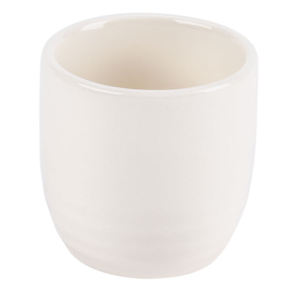 A white porcelain sake cup with a white background and a white rim.