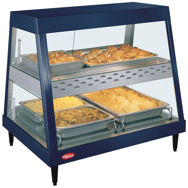 A Hatco stainless steel countertop display case with food on trays.