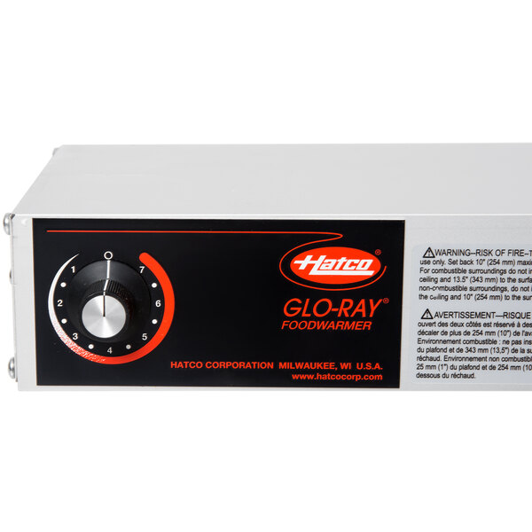 A black and white box with a dial with numbers and a red number on it.