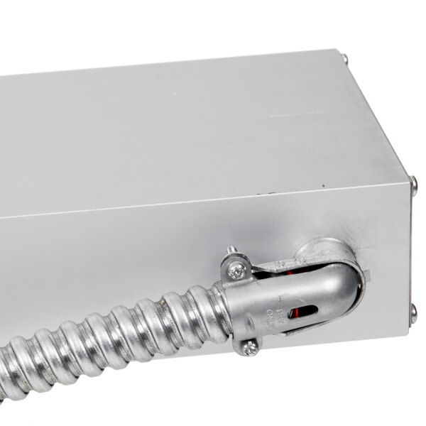 A silver metal box with a metal rod inside.