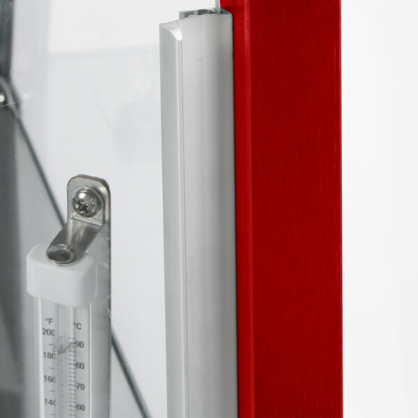 A thermometer on a red stainless steel door with a metal handle.