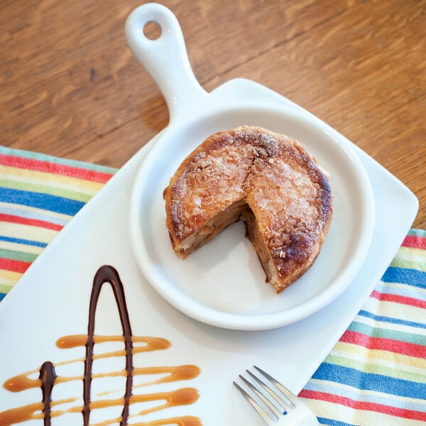 A white plate with a pastry on it.