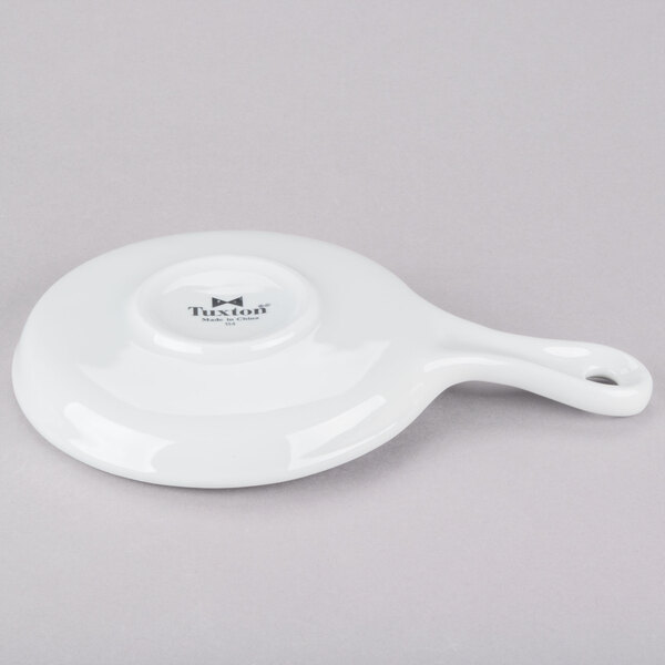 A bright white ceramic skillet with a handle.