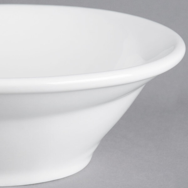 A close-up of a Tuxton bright white china bowl with a spiral pattern inside.