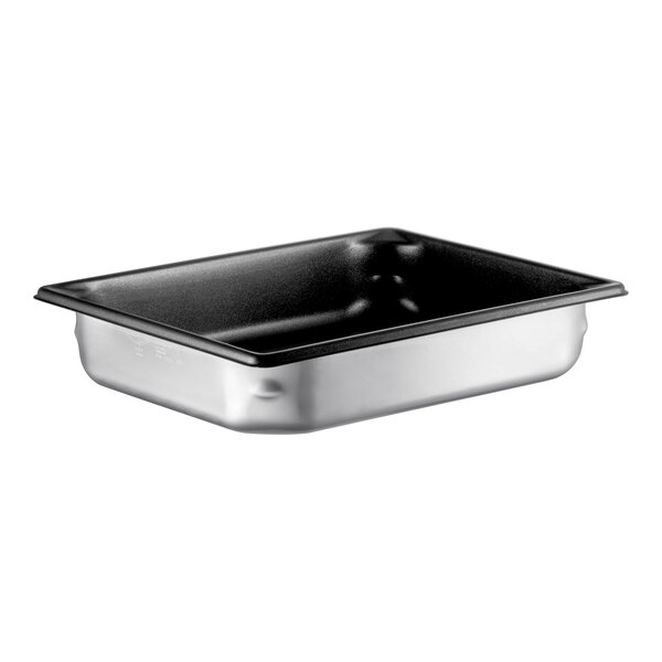 A Vollrath stainless steel pan with a black SteelCoat lid on a counter.