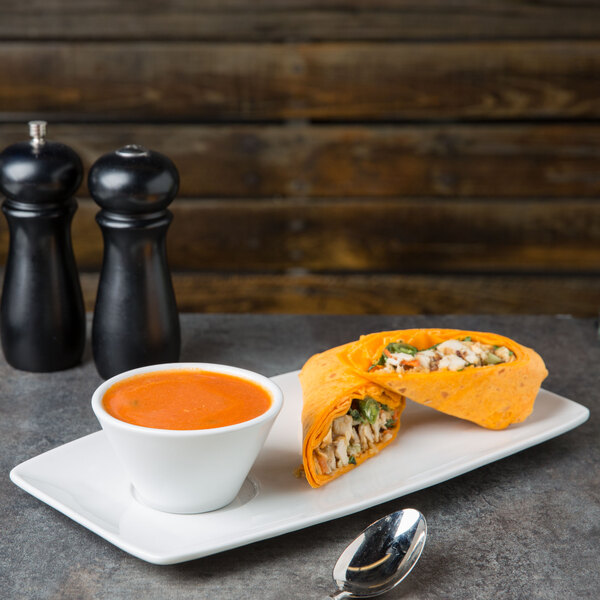 A Tuxton bright white rectangular china tray with food and a bowl of soup.