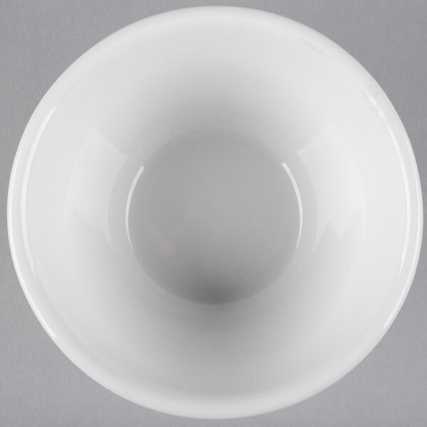 A Tuxton bright white china bouillon bowl with a hole in the middle.