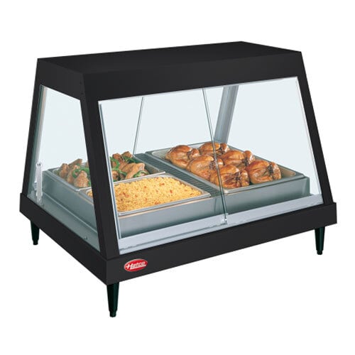 A Hatco countertop food warmer display case with cooked chicken on a tray inside.