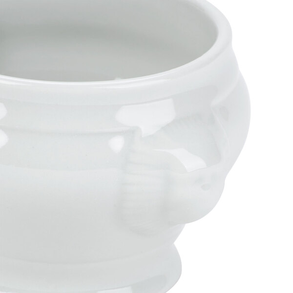 A Tuxton bright white china soup tureen with a lion head lid.