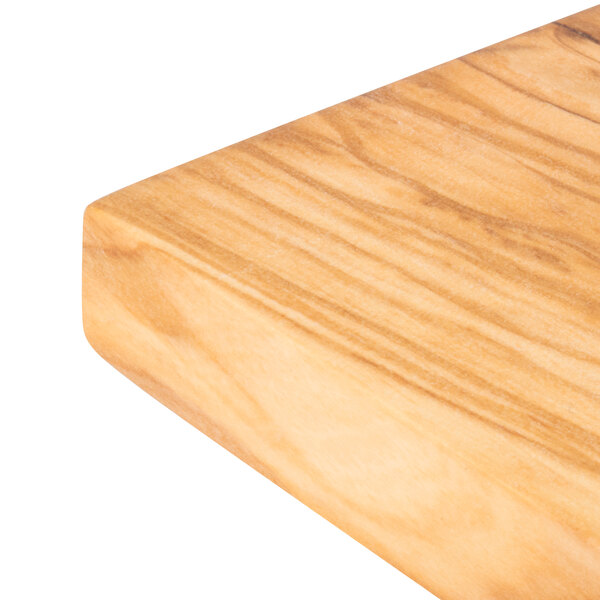 An American Metalcraft olive wood serving board on a wood surface.