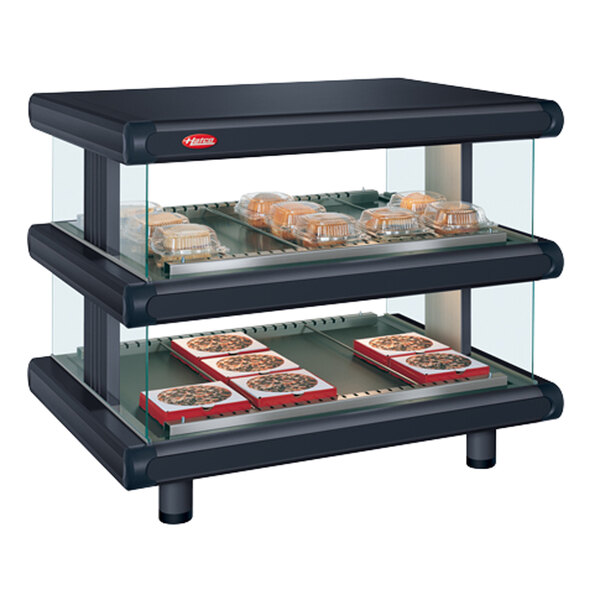 A black Hatco countertop food warmer with food trays in a glass case.