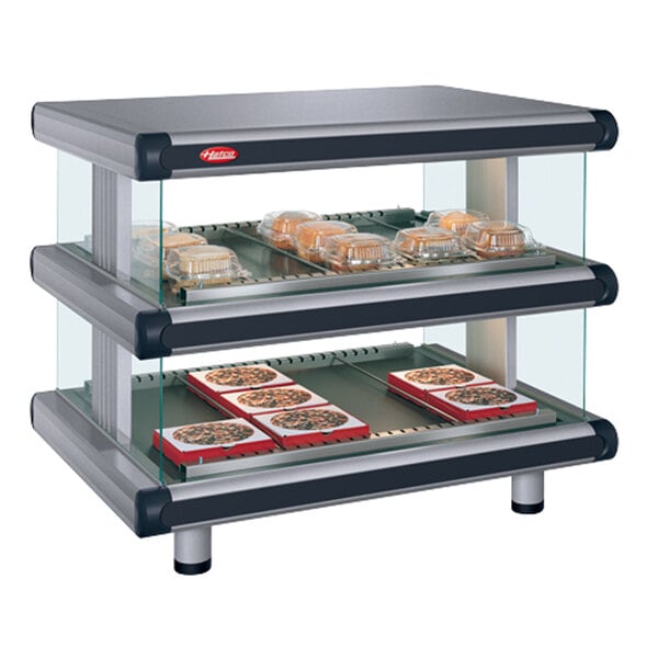 A Hatco Gray Granite Glo-Ray double shelf hot food display case with trays of pizza on it.