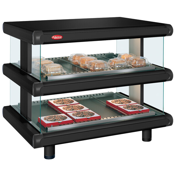 A black food warmer with trays on top.