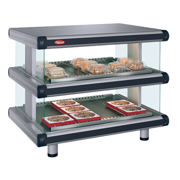 A Hatco countertop food display warmer with trays of pizza in it.