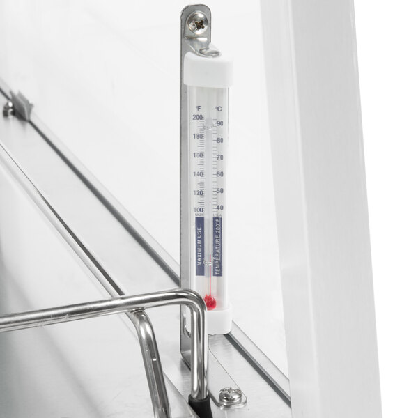 A thermometer attached to a metal rack inside a Hatco countertop food warmer.