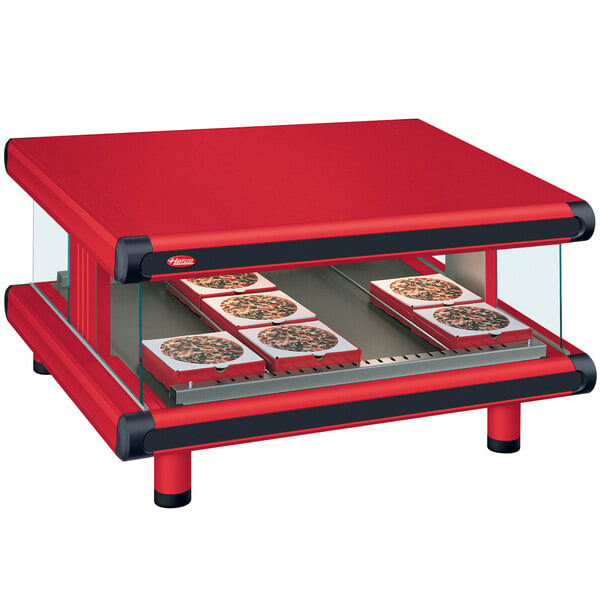 A red Hatco countertop hot food warmer with trays of pizzas.