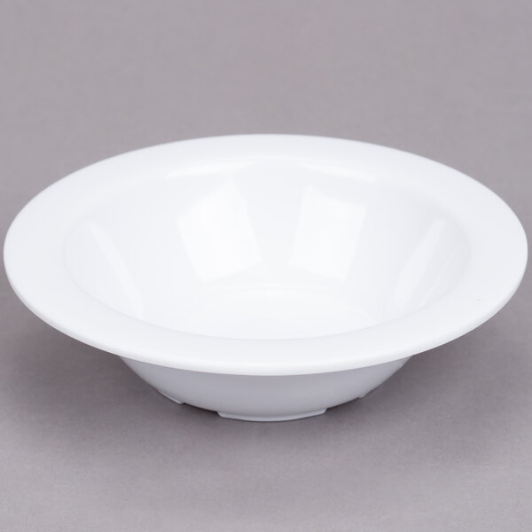 A white Thunder Group Nustone melamine monkey dish on a gray surface.