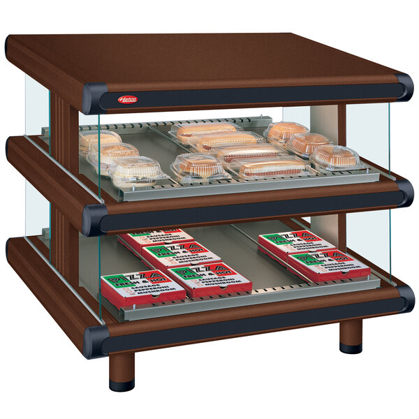A Hatco Antique Copper countertop display case with food on shelves.