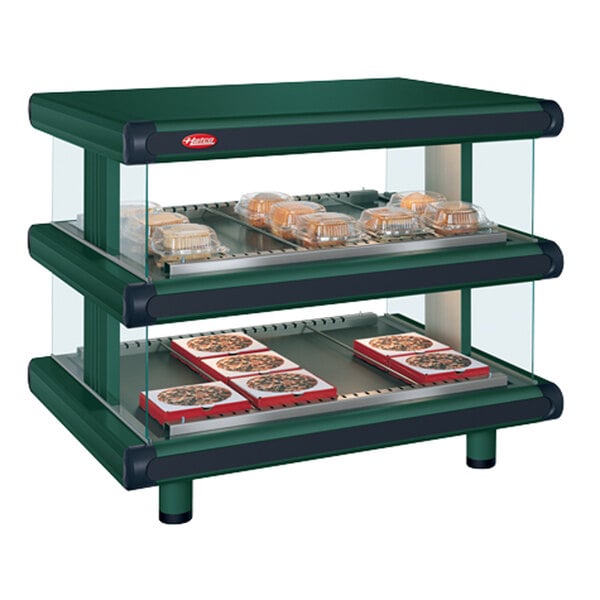 A Hunter green Hatco countertop display case with food on it.