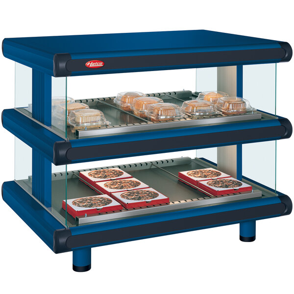 A navy blue Hatco food warmer with trays of food on it.