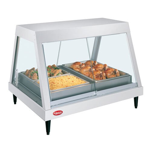 A Hatco countertop display case with food trays of cooked chicken and rice.