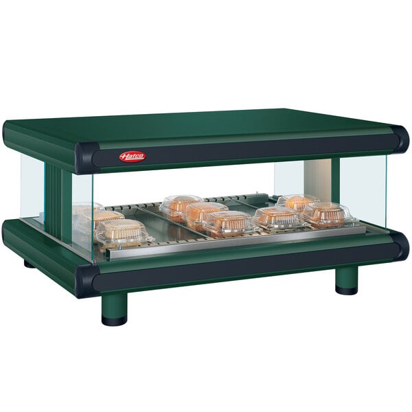 A Hunter Green Hatco countertop food warmer with food on a shelf.